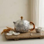 Pure 999 Fine Silver Handcrafted Silver Teapot with Intricate Floral Engravings and Amber-Toned Handle - Handicraft